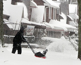 William D LEwis The vindicator  Brandon fleming uses a snowblower ot clear his drive along Euclid in Boardman Wed afternoon.