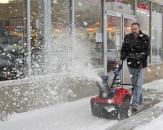 William D LEwis The vindicator Jared Pekar, sales mgr of Do Cut in Boardman uses a  snow blower in front of his store.  By 1:30pm Wed he said the store sold 40 snow blowers.