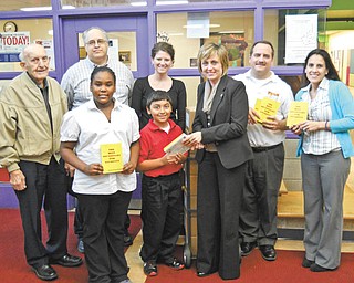 Struthers Rotary continues to participate in the dictionary project with local schools. Students in third and fourth grades at Campbell, Lowellville, St. Nicholas and Struthers schools will receive dictionaries. More than 3,000 dictionaries have been distributed since the program began. In front is Rotarian Lisa Daprile shown presenting dictionaries to Le’Asia Gibbs, left, and Zachary Luciano, who represent the third- and fourth-graders at Campbell Elementary. In the second row are Rotarians Paul Paris, left, and Tom Baringer, Campbell Elementary teacher Lori Ladigo, Rotarian Bryan Higgins and Campbell Elementary teacher Annette Tovarnak.