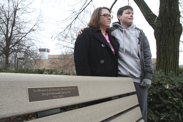 Lorraine “Carrie” Rosine, left, and Krysti Horvat stand near a bench on the campus of Youngstown State University dedicated to Rosine’s 20-year-old daughter, Brandy Stevens-Rosine, who was murdered earlier this year. Benefit events and bracelet sales funded the purchase of the bench.