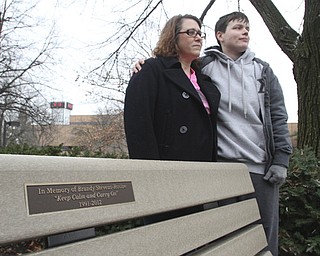 Lorraine “Carrie” Rosine, left, and Krysti Horvat stand near a bench on the campus of Youngstown State University dedicated to Rosine’s 20-year-old daughter, Brandy Stevens-Rosine, who was murdered earlier this year. Benefit events and bracelet sales funded the purchase of the bench.