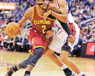 Cleveland Cavaliers guard Kyrie Irving (2) drives to the net against Washington Wizards guard Garrett Temple during the first half of Wednesday’s NBA game in Washington. The Cavaliers downed the Wizards, 87-84, with Irving posting a game-high 26 points.