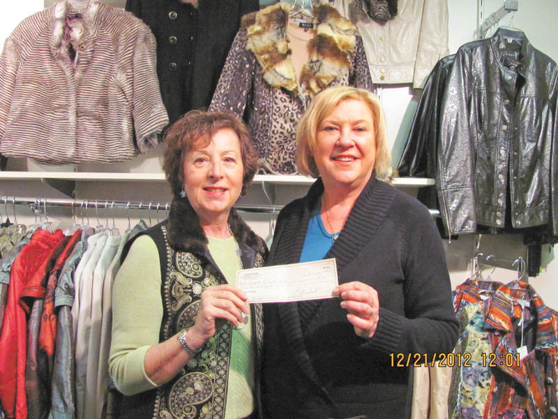 Jeannine Hodge, left, Angels of Easter Seals Holiday Brunch chairwoman, is shown receiving a $250 check from Linda Deckant, owner of Possessions, a women’s boutique in Boardman, who shared proceeds from accessories sold at the brunch.