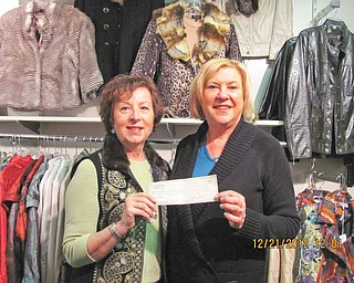 Jeannine Hodge, left, Angels of Easter Seals Holiday Brunch chairwoman, is shown receiving a $250 check from Linda Deckant, owner of Possessions, a women’s boutique in Boardman, who shared proceeds from accessories sold at the brunch.