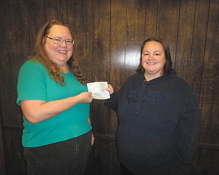Mary Mahan, left, of Emmanuel Community Care Center in Girard, accepts a check from Bree Quesenberry, Girard Junior Women’s Club president. The club donates to the center for Christmas and Thanksgiving to help provide for needy families in Girard. In 2011, the club donated 400 bags of food and IGA gift certificates for Thanksgiving and 600 presents for Christmas to families who qualified.