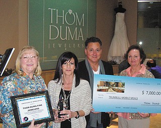 Trumbull Mobile Meals Inc. was the beneficiary of the generosity of Jacki and Thom Duma, center, of Thom Duma Fine Jewelers at their annual Basket Extravaganza. The jewelers donated a $6,000 diamond and a cubic zirconia for each of the 100 baskets in the silent auction. The winner of the silent auction basket redeemed the zirconia for the diamond at the end of the evening. Also shown are Sandee Mathews, left, chief executive officer of Trumbull Mobile Meals, and Kathy Keeler, mobile meals office manager.