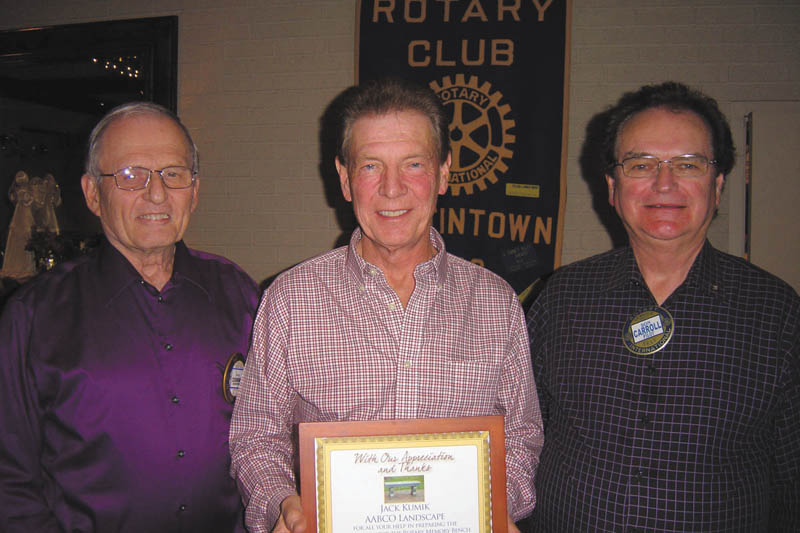 The Rotary Club of Austintown presented landscaper Jack Kumik of AABCO Landscape, center, with a plaque in appreciation for his help preparing the foundation for the Rotary memory bench placed at the Celebration Grove at Austintown Township Park. Also shown are Tony Cebriak, left, chairman of the park project, and Ron Carroll, Rotary president. Kumik aided the club in establishing the grove and continues helping with maintenance at the park.
