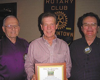 The Rotary Club of Austintown presented landscaper Jack Kumik of AABCO Landscape, center, with a plaque in appreciation for his help preparing the foundation for the Rotary memory bench placed at the Celebration Grove at Austintown Township Park. Also shown are Tony Cebriak, left, chairman of the park project, and Ron Carroll, Rotary president. Kumik aided the club in establishing the grove and continues helping with maintenance at the park.
