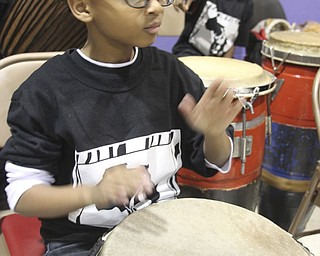 William D Leiws the Vindicator  Isaiah Carter, 9, member of Harambee drum corp plays during KwanzaacelebrationTuesday at McGuffey Centre.