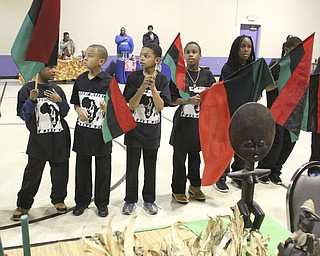 William D Lewis the Vindicator Youth hold African flags during Kwanzaa celebration Tuesday at McGuffey Centre.