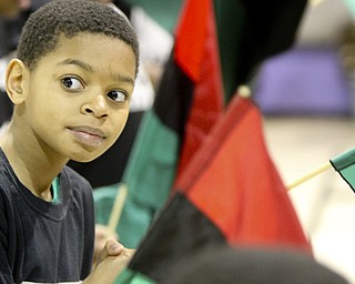 William D Leiws the Vindicator Tyler Wagner,11, holds an african flag during Kwanzaa celebration Tuesday at McGuffey Centre.