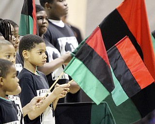 William D Lewis the Vindicator Tyler Wagner,11, holds an african flag during Kwanzaa celebration Tuesday at McGuffey Centre.