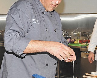 Chef Daimer Cescon of Venice, Italy, cooks in the new kitchen at D’Vino.