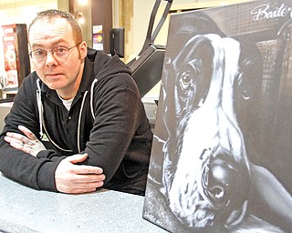 Josh Shaull, owner of Airtistix Airbrush in Eastwood Mall, displays his painting of a Great Dane named Baxter. At top, Shaull airbrushes details on a T-shirt.