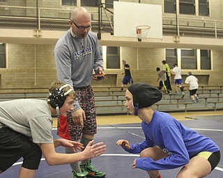 William D Lewis the Vindicator Hubbard sophomore wrestler Shirley Flynn prepares to wrestle C.J. Latronico, a Hubbard freshman in the 106 pound class during a recent practice. Coach Don Newell Jr. is in background. She is one of just a few girl wrestlers in the state.