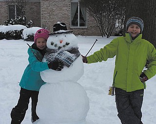 Marissa and Mario Antonelli, 8 and 10, respectively, grandchildren of Ron and Bridget Antonelli of Liberty Township, are enjoying the winter snowstorm during their recent holiday visit here with their parents, Tammy and R.J. Antonelli, from Raleigh, N.C. They made a great snowman with acorn eyes, a carrot nose and broccoli sprouts for its mouth. The snow was a real treat for everyone..