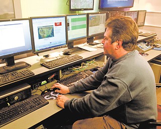 Mark Koontz, chief meteorologist for 21 WFMJ-TV, works on a forecast at the station. Koontz is retiring, and his final weather report will be today.