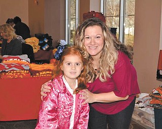 Above, Addison Miller, a kindergarten student at Holy Family Parish in Poland, and her mom, Jacci Miller, search for the perfect gifts at a recent Santa’s Workshop at the center. Jacci also was one of the coordinators of this year’s workshop. Below, Gianna Bindas, also a kindergarten student at Holy Family, and her father, Tom Bindas, also shop at the workshop.