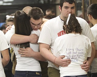 William D. Lewis the Vindicator Wilmington HS students embrace before Sat.1-5-13 basketball game at their school. A classmate was killed friday in a traffic accident. They are from left Alexa Bretz, 10th grade, Ethan Seeber, 11th grade, Dakota Boyle, 10th grade and Emily reed, 10th grade.
