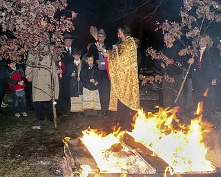 William D Leewis The Vindicator Rev Milan Medakovic conducts blessing during Christmas eve service Sunday 1-7-12 at Holy Trinity Serbian Orthodox Church in Youngstown. The yule logs were then placed on hte fire outside the church.