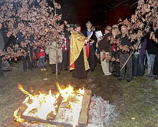 William D Leewis The Vindicator Rev Milan Medakovic conducts blessing during Christmas eve service Sunday 1-7-12 at Holy Trinity Serbian Orthodox Church in Youngstown. The yule logs were then placed on hte fire outside the church.