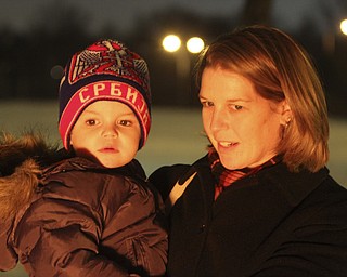 William D Leewis The Vindicator Lisa Milosevic holds her son Luka, 2, as the watch burning of the yule log during Christmas eve service Sunday 1-7-12 at Holy Trinity Serbian Orthodox Church in Youngstown.