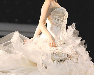 Holly Naples of Warren models a wedding gown Sunday during the Premier Bridal Show at the Covelli Centre. The bridal show sponsored by Evaline’s Bridal and Thom Duma Fine Jewelers, both of Warren, attracted wedding
vendors and throngs of prospective brides from across the region.