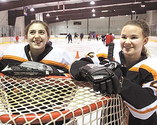 The Canfield High hockey team includes two female players — goaltender Megan Cole, left, and forward Brittany Bettile. Both are juniors.
