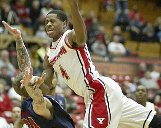 William D Lewis the Vindicator Shawn Amiker of YSU (4) collides with Detroit's Nick Minnerath(34) during 1rst half action Thursday 1-9-13 at YSU. Minnerath was charge with a foul.