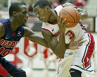 William D Lewis the Vindicator YSU's Kendrick Perry(3) keeps the ball from Jason Calliste(10) of Detroit during 1rst half action Thursday 1-9-13 at YSU.