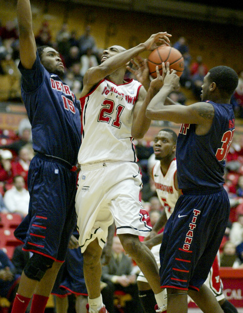 William D Lewis the Vindicator YSU's Damian Eargle(21) is hemmed in by Detroits Ugochukwu Njoku(15) and Anton Wilson (32) during 1rst half action Thursday 1-9-13 at YSU.