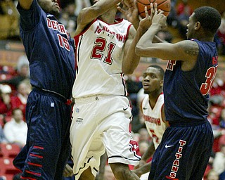 William D Lewis the Vindicator YSU's Damian Eargle(21) is hemmed in by Detroits Ugochukwu Njoku(15) and Anton Wilson (32) during 1rst half action Thursday 1-9-13 at YSU.