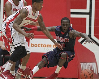 William D Lewis the Vindicator YSU's Shawn Amiker(4) and Detroit's Jason Calliste(10) during 1rst half action Thursday 1-9-13 at YSU.