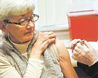 Jeanie Price of Austintown got her influenza shot Thursday at the Mahoning County health department on Westchester Drive, Austintown. Nurses administered about 350 doses of vaccine during clinics Tuesday , Wednesday and Thursday.