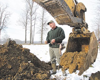 Stephen Prebonick, a state soil scientist, analyzes soil to determine whether a proposed pond site has characteristics that will allow a pond to hold water.