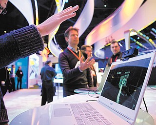 Convention attendees tried out Intel’s Creative Interactive Gesture Camera development kit at the Consumer Electronics Show on Friday in Las Vegas.