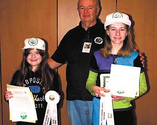 The Men’s Garden Club of Youngstown recently honored two members of its Youth Gardening Program. Dave Causer, program coordinator, presented certificates to 9-year-old Greta Graffius, left, and Katelynne, McHugh, 12, for their third place finishes in the national sunflower growing contest. Each of the girls grew a sunflower head measuring 14 inches. For information about the youth program call Causer at 330-548-3669.