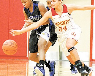 Youngstown Christian’s Kayla Rios (14) and Cardinal Mooney’s Brie Ozenghar (24) chase a loose ball during the first half of a game Monday night. Youngstown Christian won, 39-35.