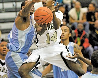 Warren Harding’s King Garner (14) goes for a layup during the Raiders’ game against East on Tuesday at Warren.
