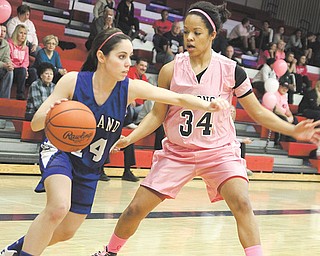 Poland’s Rachael Robertson (14) tries to get past Fitch defender Briana Edwards (34) during the Falcons’ fourth annual “Think Pink Game” on Thursday at Fitch High School in Austintown. The Falcons defeated the Bulldogs, 46-25.
