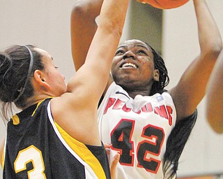 Youngstown State’s Brandi Brown (42) puts up a shot against Wisconsin-Milwaukee’s Emily Decorah (3)
during the first half of Thursday’s game at YSU’s Beeghly Center. Brown posted 18 points in the Penguins’
67-50 win over the Panthers.