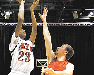 Struthers’ Ray’Quan Phifer (23) shoots over Hickory’s Marcus Sonoga during the first quarter of their game Tuesday at the Covelli Centre. Hickory won 60-33.