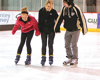 Unusually cold conditions Tuesday closed most Mahoning Valley schools. As a results, many students hit the ice at the indoor Ice Zone in Boardman. At left, from left, Taylor Vanasdale, 14; Alexis Madeline, 17 and Jared
Vanasdale, 17 enjoy their unexpected day of recreation. Conditions will remain cold today with wind chills dropping to minus 17.