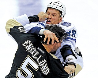 Pittsburgh Penguins defenseman Deryk Engelland (5) and the Toronto Maple Leafs Colton Orr (28) throw
punches during the first period of their NHL game Wednesday at Consol Energy Center in Pittsburgh. The Maple
Leafs won 5-2. It was Pittsburgh’s first loss of the season.