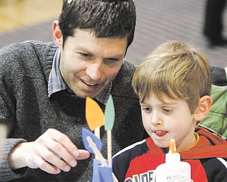 Shlomo Jacobs-Velde, 4, concentrates on putting foam and paper pieces together to make a floral centerpiece during a program related to Tu B’Shevat, the “new year” for trees in the Jewish tradition. Shlomo and his father, Rabbi Josh Jacobs-Velde of Congregation Ohev Tzedek in Boardman, attended the program this week at Temple El Emeth in Liberty.