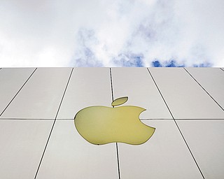 The Apple logo is seen on an Apple store in San Francisco. Apple shares plunged Thursday after the company reported quarterly results that point to slowing growth after five blowout years.