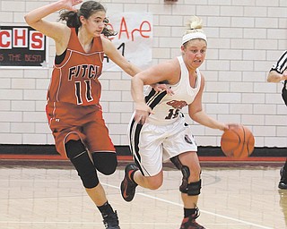 Canfield’s Paige Baker (10) tries to get past Fitch defender Megan Sefcik (11) during their basketball game Thursday at Canfield High School. The Cardinals defeated the Falcons, 63-57.