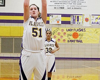 Champion’s Mackenzie Kiser shoots her 1,000th career point on a free throw during the first period of a game Thursday against Campbell at Champion High School. The Golden Flashes routed the Red Devils, 61-22.