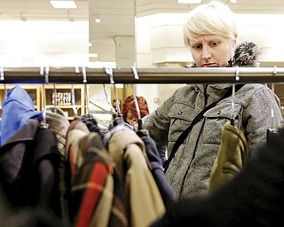 In this Jan. 20 photo, a woman shops at a Nordstrom store in Chicago. U.S. consumer confidence plunged in January to its lowest level in more than a year, reflecting higher Social Security taxes that left Americans with less take-home pay.