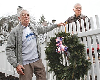 Ted Heineman, left, and Dave Smith place a wreath where President William McKinley’s boyhood home once stood in celebration of McKinley’s 170th birthday. Both men are members of the Poland Historical Society and Town One Streetscapes, which organized Tuesday’s commemoration. McKinley, pictured top left in his Civil War uniform, graduated from Poland schools and later worked as a postal clerk and teacher in Poland.